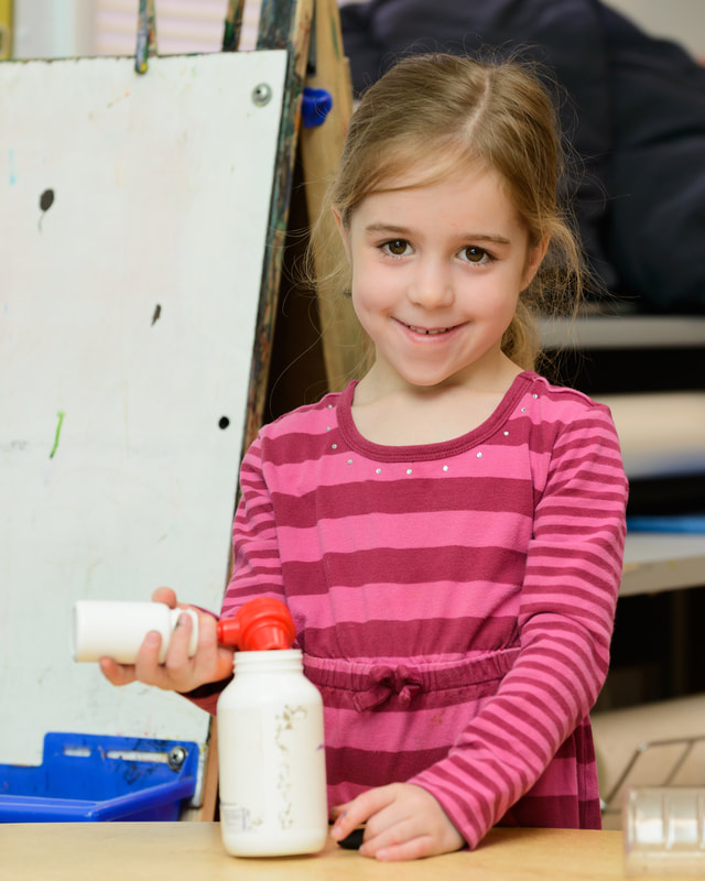 Child smiling with arts and crafts